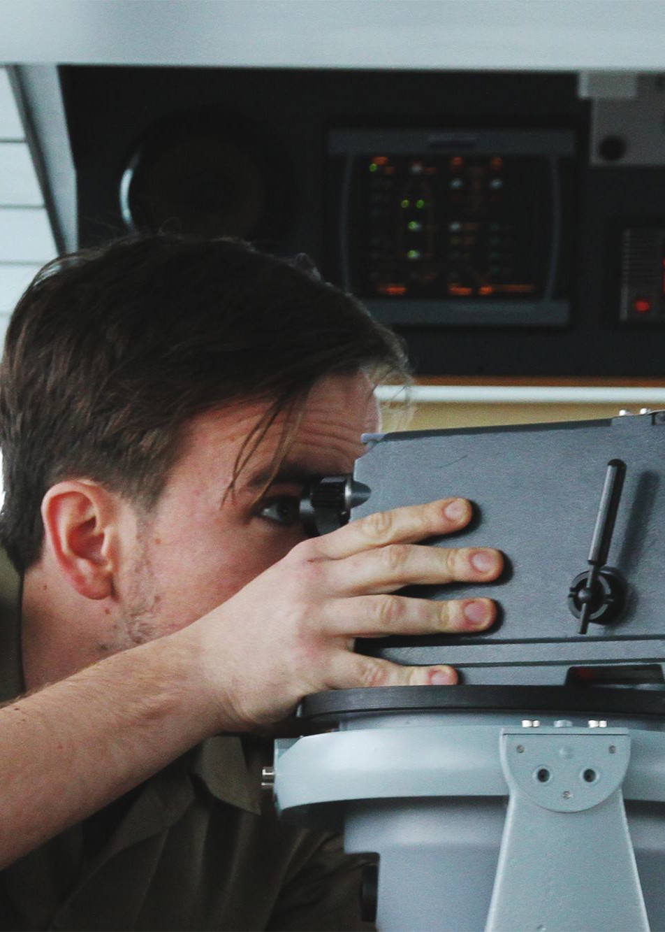 En sergent på et skib bruger en kikkert