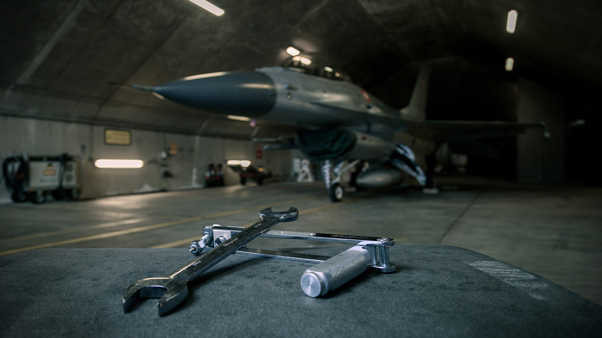 Et af Forsvarets fly med værktøj i forgrunden