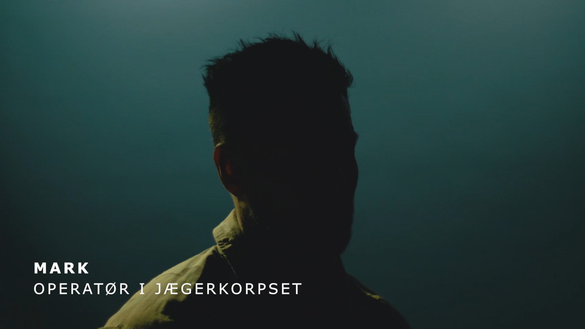 Silhuet af Mark, operatør i Jægerkorpset, mod mørk baggrund.